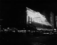 Canal Street building at night decorated for Mardi Gras