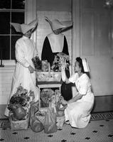 DePaul Hospital, nuns and nurse with baskets of groceries