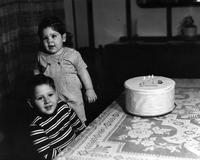 Girl and boy with birthday cake