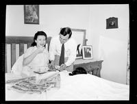 Man Serving Breakfast in Bed to a Woman