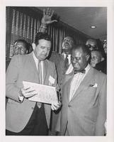 George Healy showing Louis Armstrong the International House award