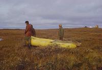 Dragging raft across tundra for lake survey