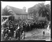 Crowd gathered outside an old church building
