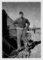 Soldier standing next to tents