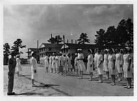 Nurses lined up outside of three buildings
