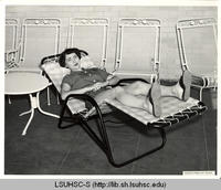 Nursing student sunbathing on the sundeck of the Nurses' Residence