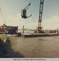 Dredging barge filling dumptruck near Raceland Louisiana