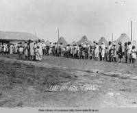 Refugees line up for food at an African American refugee camp near Baton Rouge Louisiana during the great flood of 1927