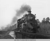 Texas and Pacific train crossing the Bayou Pierre tressell bridge in Louisiana