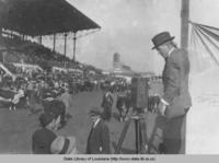 Photographer Jasper Ewing filming a livestock show at the 1916 State Fair in Shreveport Louisiana