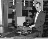Librarian Murrell C. Wellman with phonograph player and records at the State Library of Louisiana in Baton Rouge Louisiana in the 1960s