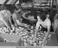 Workers filling cans with salt for the International Salt Company in New York circa 1940s