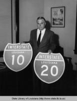 R.B. Richardson displays the highway signs to be used on the new interstate system in Louisiana in the 1960s