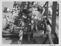 Tightening flanges on xmas tree equipment while some of patton's men swin in Vermilion Bay, 3:10pm, June 10, 1938