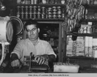 Owner of general store slicing bologna in Jarreau Louisiana in 1938
