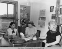 Librarian Essae Culver helping people at the Jefferson Parish library in Grand Isle Louisiana in 1952