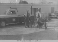 Two Assumption Parish deputies with truck and bloodhounds