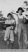 Children with doll, book, and chicken in Grand Isle Louisiana in the 1920s