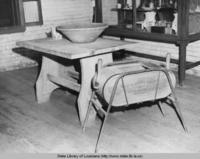 Old butter churn and furniture at the Acadian House at Evangeline State Park in Saint Martinville Louisiana in the 1950s