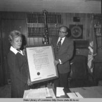Secretary of State Wade O. Martin holding a framed document in Baton Rouge Louisiana circa 1971