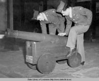Soldiers inspect a cannon at the Cabildo in New Orleans Louisiana