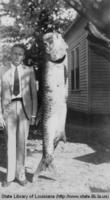 Prize winning tarpon fish and captor in Lake Charles Louisiana in the 1940s