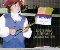 Child in patriotic costume with antique bookmobile at the Washington Parish fair in Washington Parish Louisiana in 1976