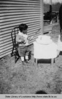Native American boy with birthday cake in White Sulphur Springs Louisiana in the 1930s