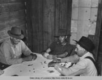 Men playing poker in home of day laborer near New Iberia Louisiana