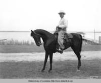 Mr. Robert L. James riding a horse in the 1940s