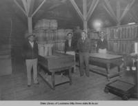Interior of Blum and Bergeron warehouse showing barrels used for shipping shrimp