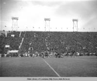 View of stadium and players at the Louisiana State University versus Tulane football game opening the new end zone built by the WPA in Baton Rouge in 1938