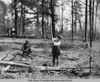 Cutting fire wood at a WPA-built refugee camp for victims of the 1937 flood in Harrisonburg, Louisiana