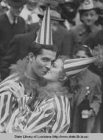 People in costume  kissing at Mardi Gras in New Orleans Louisiana in approximately 1936