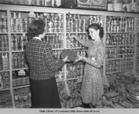 Store clerk receives library books from librarian in Port Allen Louisiana in 1940