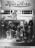 Mardi Gras wigs and costume jewelry in store window in New Orleans Louisiana in 1940s
