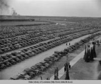 Parking area full of cars adjacent to the LSU Stadium after stadium expansion in 1938