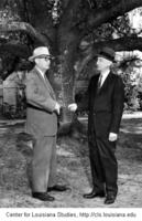 President Joel Fletcher (left) presenting an oak sapling to Harlan K. Riley.