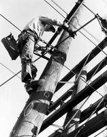 Lineman on telephone pole